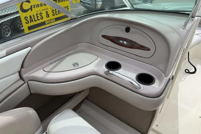 Slide: The Image of Interior of a 2003 Sea Ray 240 Bow Rider boat with cup holders and storage. - 25