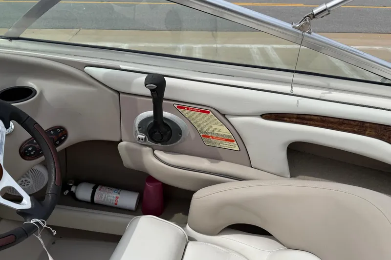 Slide: The Image of Interior of a 2003 Sea Ray 240 Bow Rider boat, featuring steering wheel and controls. - 27