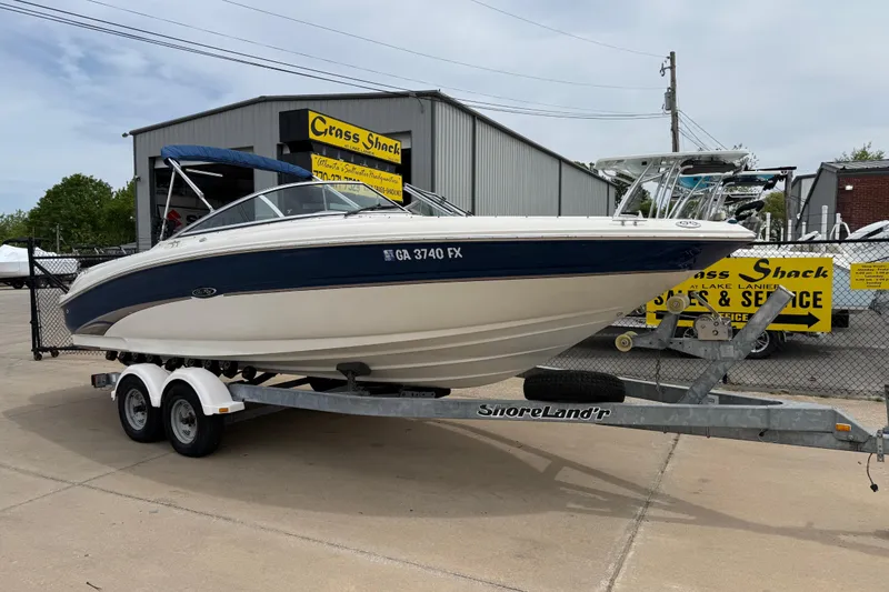 The Image of 2003 Sea Ray 240 Bow Rider on trailer at dealership, ready for sale. - 3