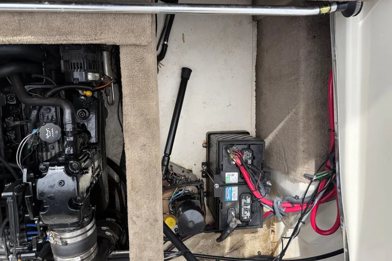 Slide: The Image of Engine compartment of a 2003 Sea Ray 240 Bow Rider with visible battery and wiring. - 32