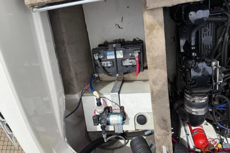 Slide: The Image of Engine compartment of a 2003 Sea Ray 240 Bow Rider with visible battery and components. - 33