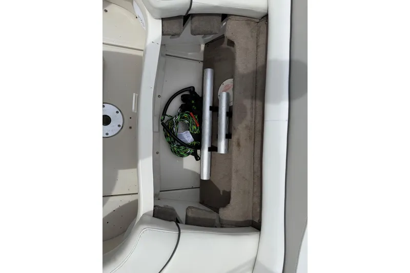 Slide: The Image of Storage compartment of a 2003 Sea Ray 240 Bow Rider boat, featuring ropes and accessories. - 36