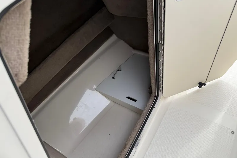Slide: The Image of Interior storage compartment of a 2003 Sea Ray 240 Bow Rider boat. - 38