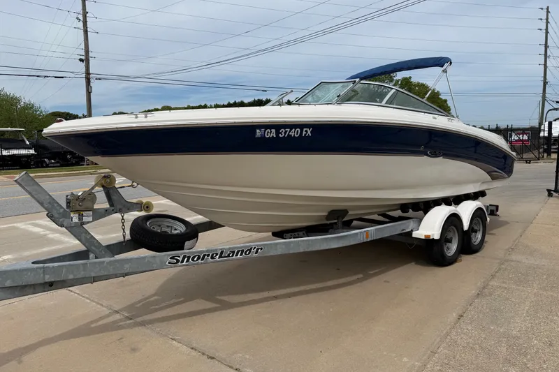 Slide: The Image of 2003 Sea Ray 240 Bow Rider on ShoreLand'r trailer, parked on a concrete surface. - 5
