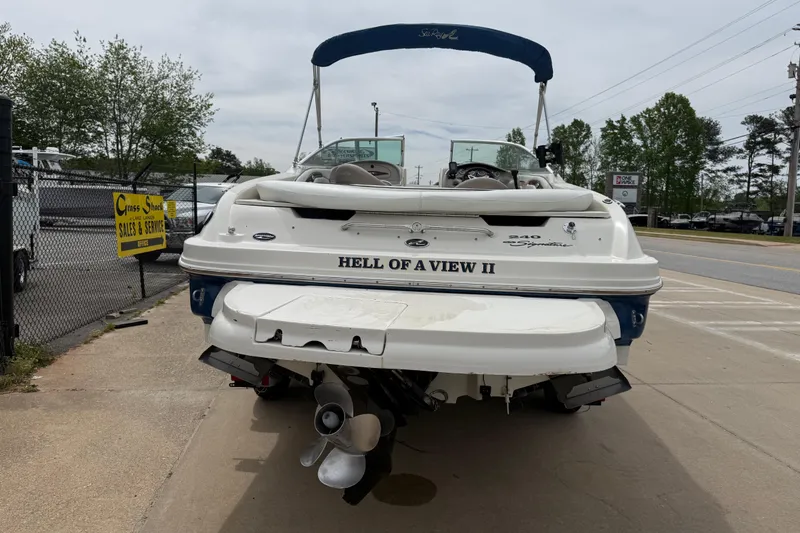 Slide: The Image of 2003 Sea Ray 240 Bow Rider boat parked on concrete, rear view. - 6