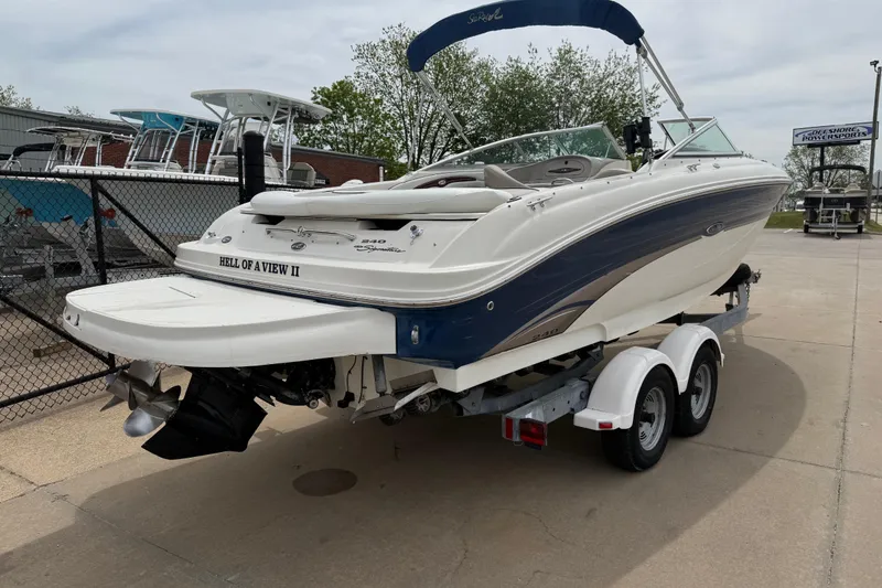 Slide: The Image of 2003 Sea Ray 240 Bow Rider boat on trailer, featuring sleek design and blue accents. - 7