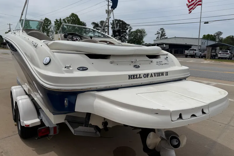 Slide: The Image of 2003 Sea Ray 240 Bow Rider boat on trailer, rear view with "Hell of a View II" name. - 8
