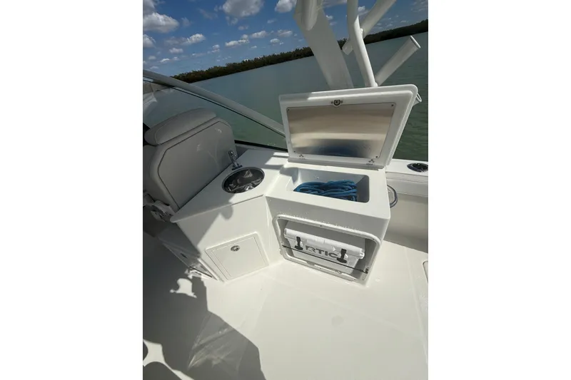 Slide: The Image of Interior of 2025 World Cat 280 DC-X boat with storage compartment open. - 13