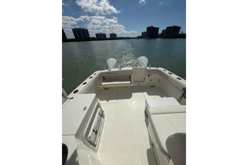 Slide: The Image of 2025 World Cat 280 DC-X boat interior with scenic waterfront view. - 14