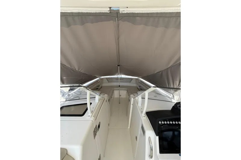 Slide: The Image of 2025 World Cat 280 DC-X boat interior with canopy, featuring sleek design and modern controls. - 17