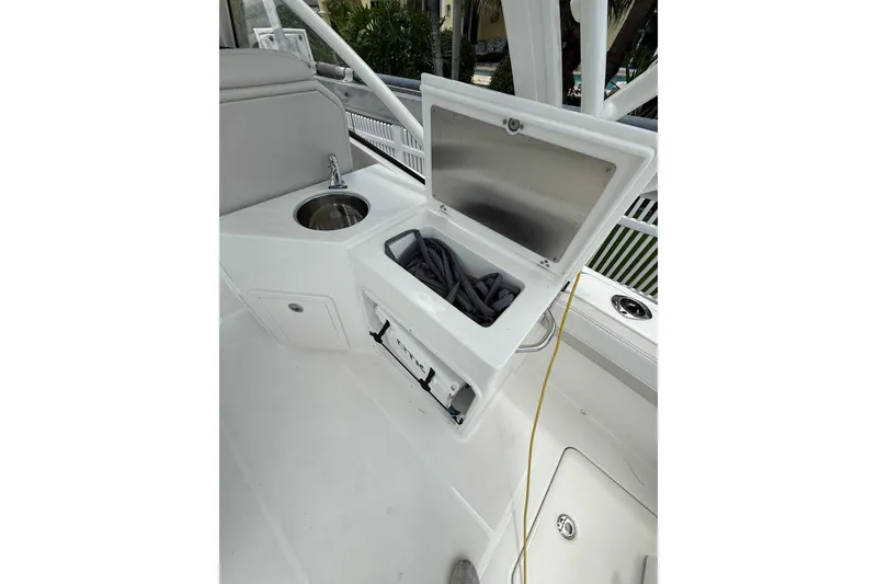 Slide: The Image of Open storage compartment on 2025 World Cat 280 DC-X boat deck. - 18