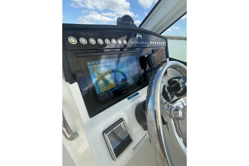 Slide: The Image of Helm of 2025 World Cat 280 DC-X boat with navigation display and steering wheel. - 5