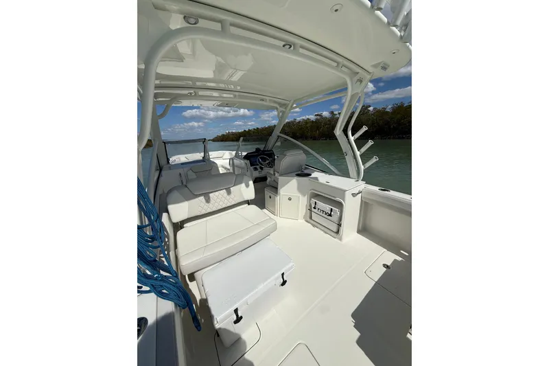 Slide: The Image of 2025 World Cat 280 DC-X boat interior with seating, steering wheel, and storage compartments. - 7