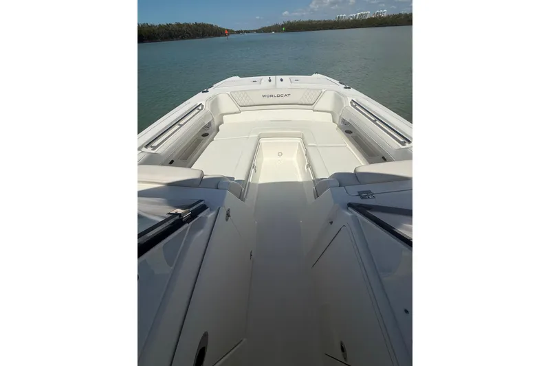 Slide: The Image of 2025 World Cat 280 DC-X boat interior, featuring spacious seating and sleek design on calm waters. - 9