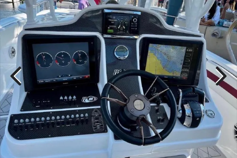 Slide: The Image of Cockpit of 2015 Deep Impact 33 boat with navigation screens and controls. - 12