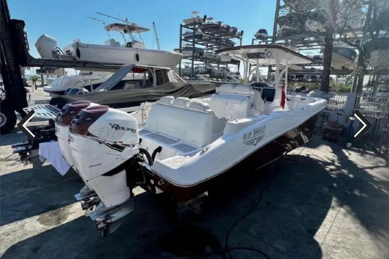 Slide: The Image of 2015 Deep Impact 33 boat with twin outboard engines in a marina setting. - 7