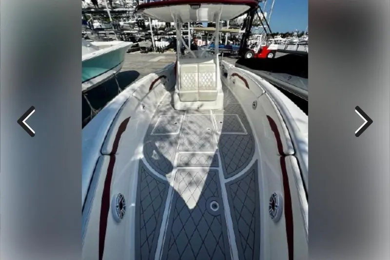 Slide: The Image of 2015 Deep Impact 33 boat deck with red accents at a marina. - 9