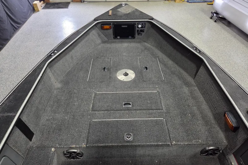 Slide: The Image of Interior view of a 1995 Lund 1775 Pro-V SE boat, featuring a spacious deck. - 6