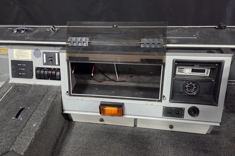Slide: The Image of 1995 Lund 1775 Pro-V SE boat dashboard with control panel and RPM gauge. - 9
