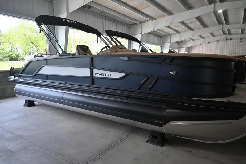 The Image of 2026 Evotti 523QL pontoon boat in a covered storage area. - 1