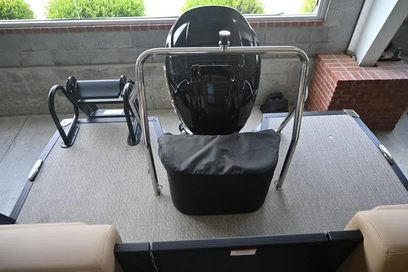 Slide: The Image of 2026 Evotti 523QL boat deck with motor and seating, in a garage setting. - 10