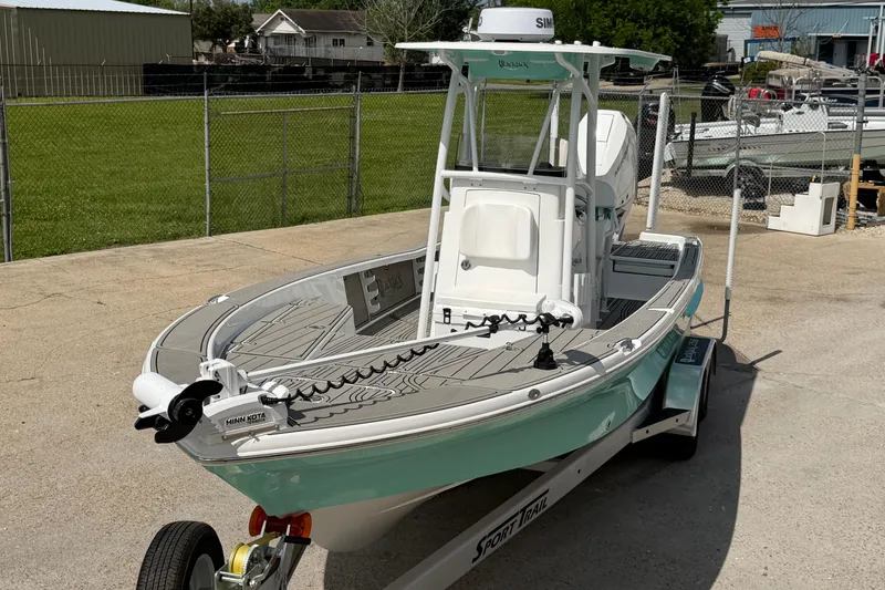 Slide: The Image of 2024 BlackJack 256 Bay boat on trailer, parked outdoors in a fenced area. - 10