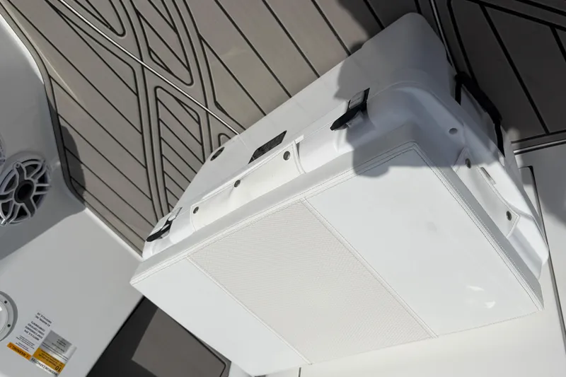 Slide: The Image of 2024 BlackJack 256 Bay boat interior with white storage compartment and speaker. - 19