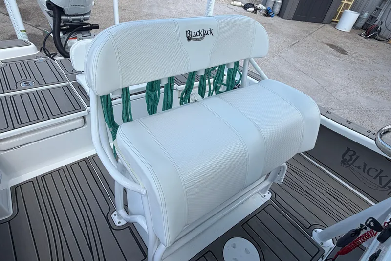Slide: The Image of 2024 BlackJack 256 Bay boat seat with white upholstery and green ropes. - 23