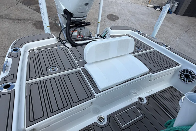 Slide: The Image of 2024 BlackJack 256 Bay boat deck with seating and motor, featuring sleek design. - 24