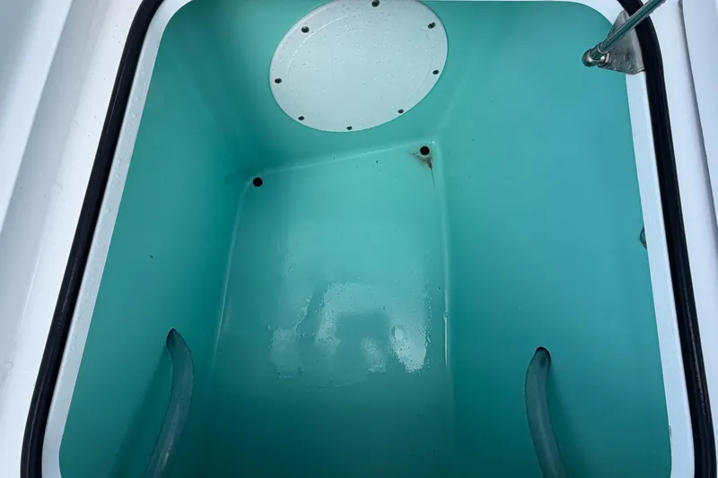 Slide: The Image of Interior view of 2024 BlackJack 256 Bay boat compartment, featuring a clean, turquoise finish. - 25
