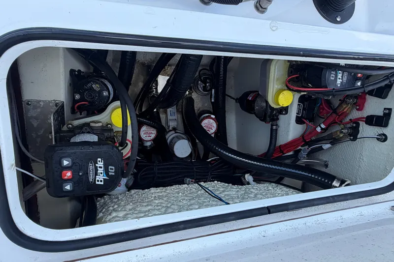 Slide: The Image of 2024 BlackJack 256 Bay boat compartment with wiring and mechanical components. - 26