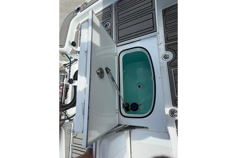 Slide: The Image of Open hatch on 2024 BlackJack 256 Bay boat, revealing storage compartment. - 29