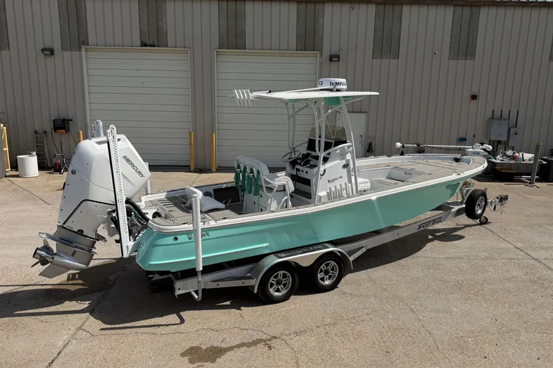 Slide: The Image of 2024 BlackJack 256 Bay boat on trailer, parked outside a warehouse. - 3