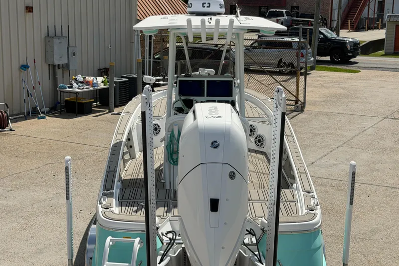 Slide: The Image of 2024 BlackJack 256 Bay boat with powerful engine, docked in a marina setting. - 5