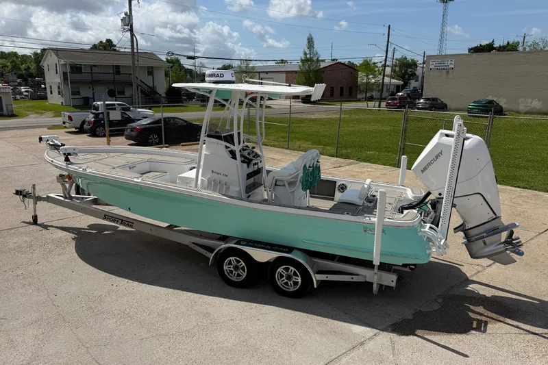 Slide: The Image of 2024 BlackJack 256 Bay boat on trailer, featuring a sleek design and powerful Mercury engine. - 7
