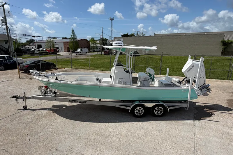Slide: The Image of 2024 BlackJack 256 Bay boat on trailer, parked outdoors under a clear sky. - 8