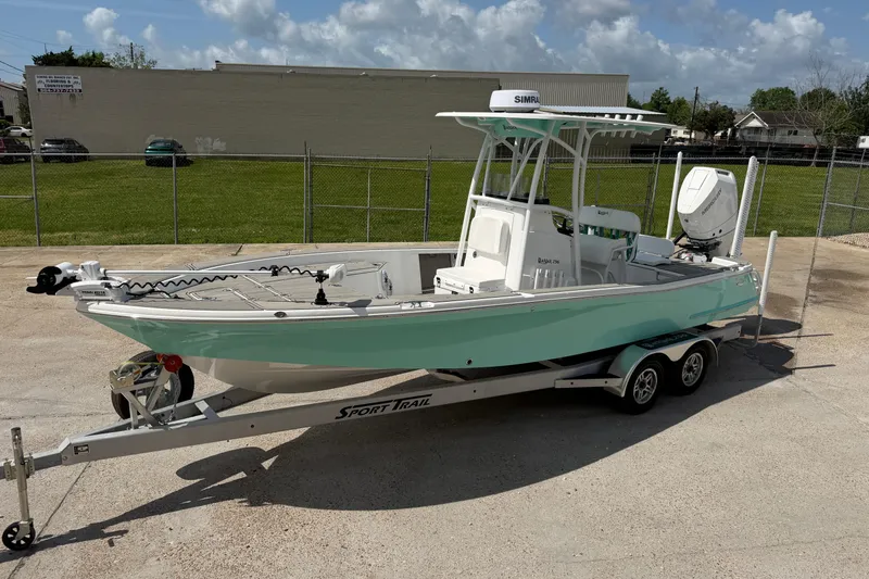 Slide: The Image of 2024 BlackJack 256 Bay boat on trailer, parked outdoors under a cloudy sky. - 9