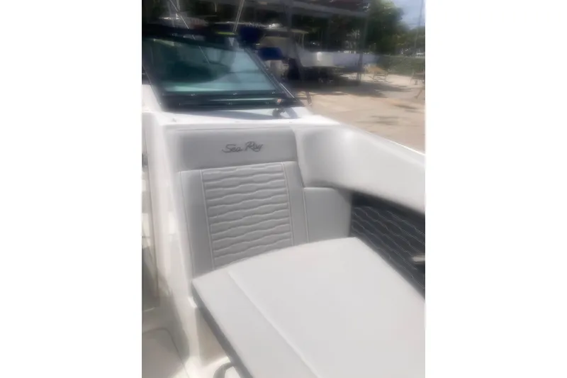 Slide: The Image of 2022 Sea Ray SPX 230 Outboard boat interior with gray seating and storage compartment. - 10