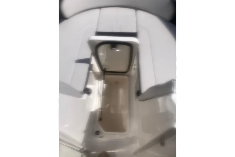 Slide: The Image of 2022 Sea Ray SPX 230 Outboard boat interior with cushioned seating and speaker. - 13