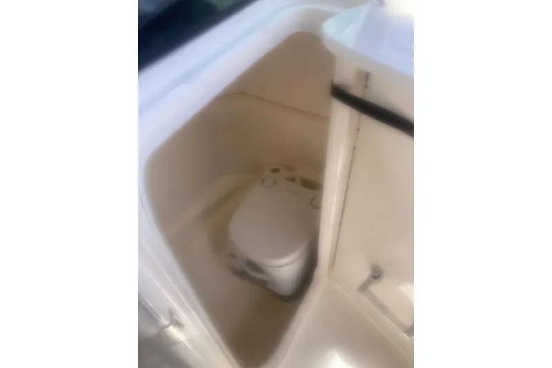 Slide: The Image of 2022 Sea Ray SPX 230 Outboard boat interior with gray seating and speaker detail. - 14