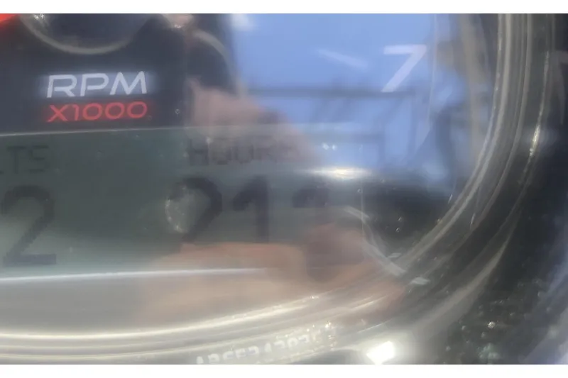 Slide: The Image of 2022 Sea Ray SPX 230 Outboard boat cockpit with steering wheel and control panel. - 19