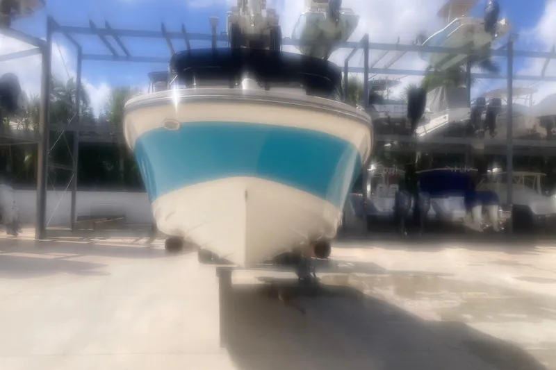 Slide: The Image of 2022 Sea Ray SPX 230 Outboard boat named "Popi Time" with blue and white hull. - 2