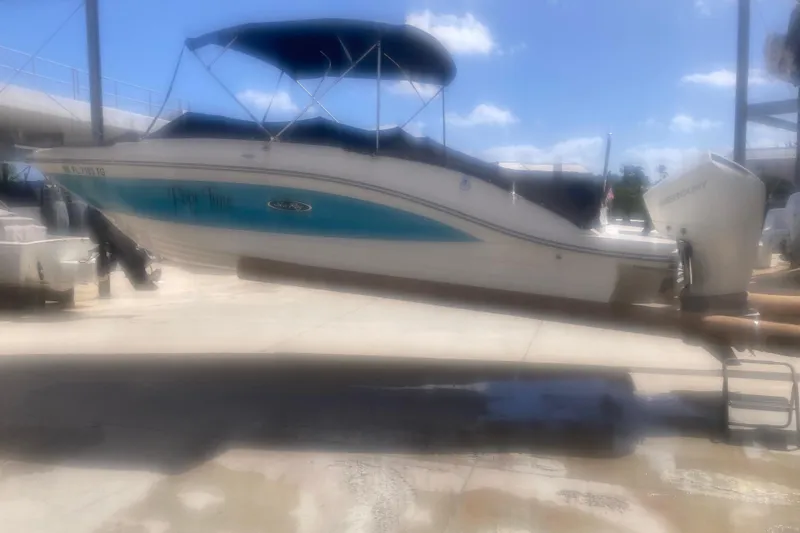 Slide: The Image of 2022 Sea Ray SPX 230 Outboard boat with Mercury engine, docked under a canopy. - 3