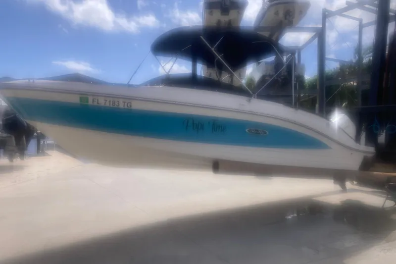Slide: The Image of 2022 Sea Ray SPX 230 Outboard boat with Mercury engine, docked under a canopy. - 4