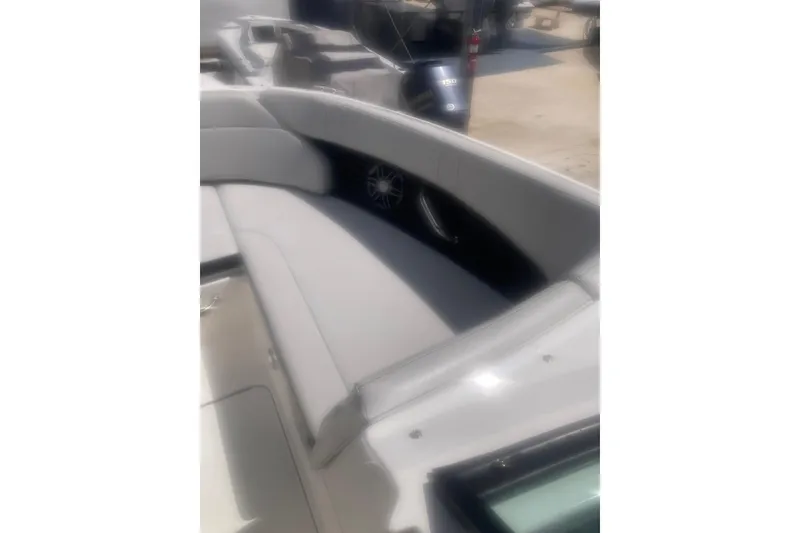 Slide: The Image of 2022 Sea Ray SPX 230 Outboard boat with blue hull, docked under a clear sky. - 7