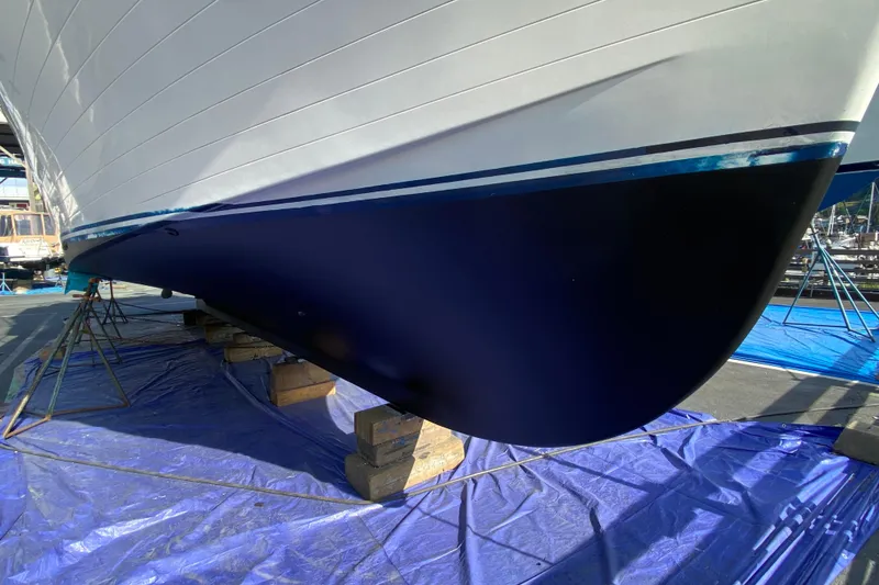 Slide: The Image of 1982 C & L Sea Ranger boat hull on stands, undergoing maintenance in a shipyard. - 10