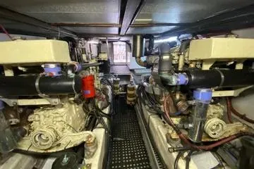 Slide: The Image of Engine room of a 1982 C @ L Sea Ranger boat, showcasing dual engines and mechanical components. - 102