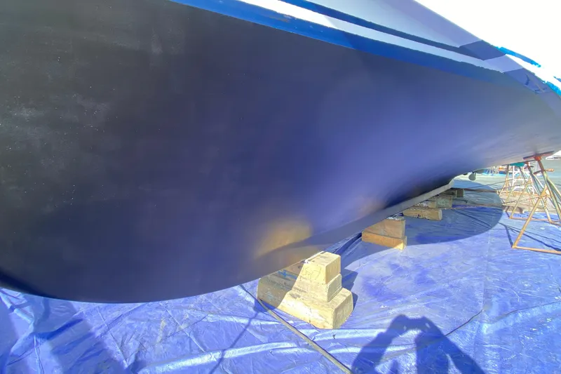 Slide: The Image of Hull of 1982 C & L Sea Ranger boat on blocks, under maintenance. - 11