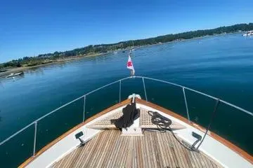 Slide: The Image of Bow view of 1982 C @ L Sea Ranger boat on calm water under clear blue sky. - 15