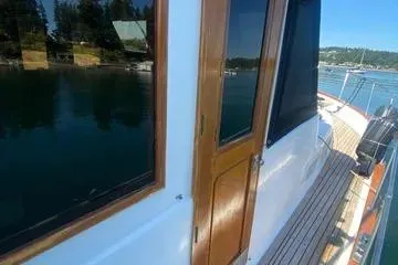 Slide: The Image of 1982 C @ L Sea Ranger boat with wooden door and scenic water view. - 19